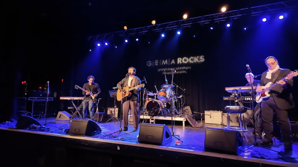 people on a stage playing music with the words "GEMA Rocks" in the background